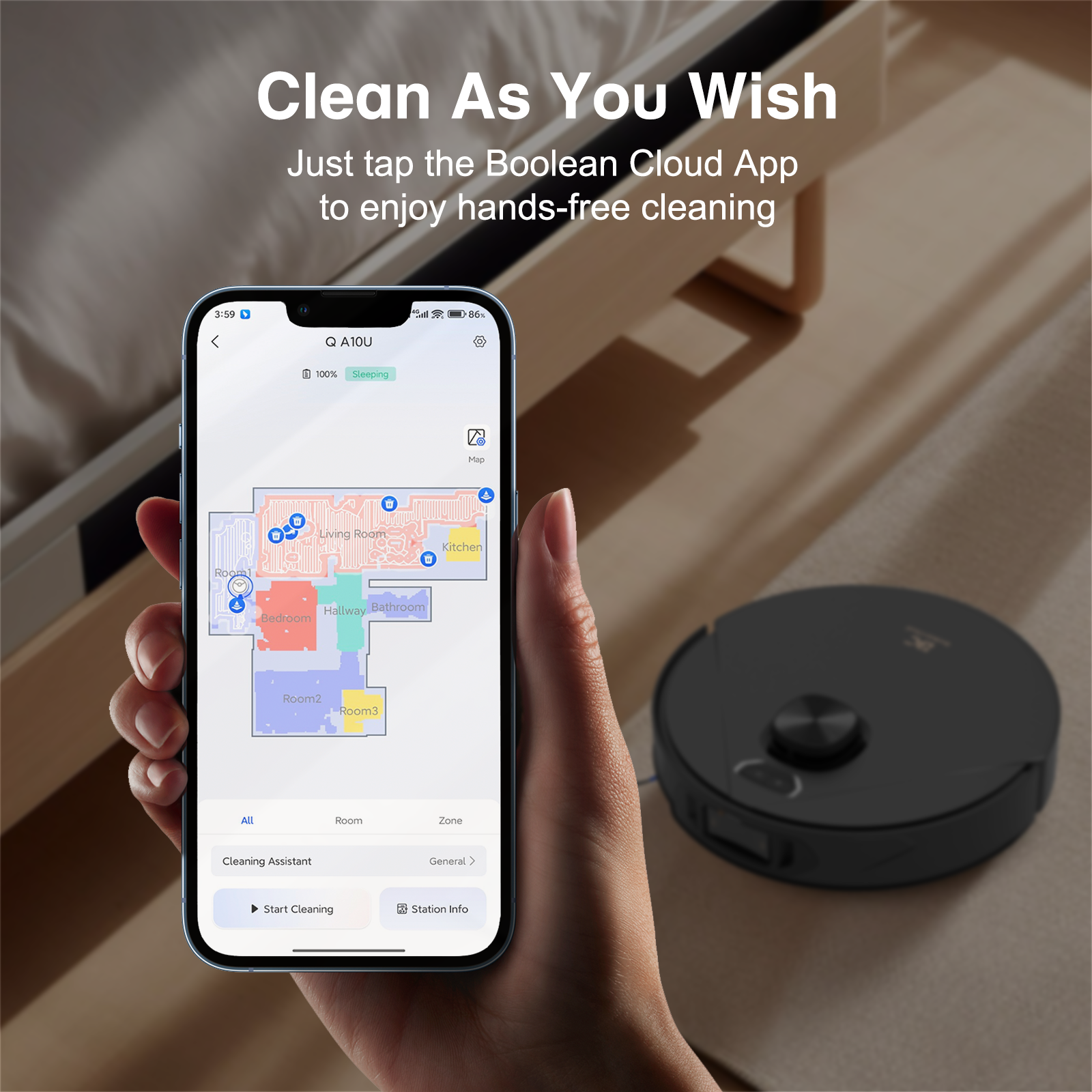 Hand holding smartphone showing Boolean Cloud App for hands-free cleaning with robot vacuum on floor